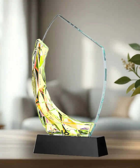 Colorful glass sculpture award on a black pedestal in a bright room.